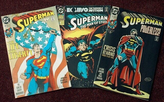 An undated photo shows three editions of the 'Superman' comic book. (AP Photo/ Ed Bailey)