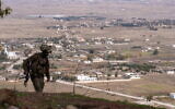An IDF soldier is seen at a former Syrian Army post at Tel Kwdana, Syria, December 11, 2024. (Emanuel Fabian/Times of Israel)