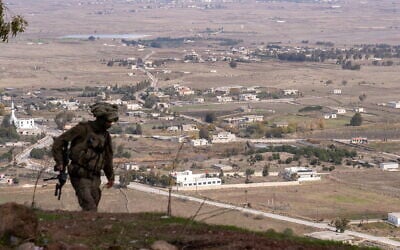 An IDF soldier is seen at a former Syrian Army post at Tel Kwdana, Syria, December 11, 2024. (Emanuel Fabian/Times of Israel)