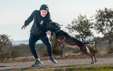 A trainer from Israel Protection K9 with one of the company's dogs. (Courtesy)