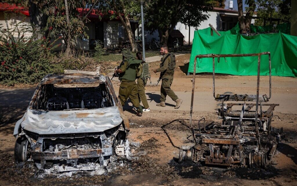 IDF troops walk through Kibbutz Nahal Oz, near the Gaza border, on October 20, 2023, following the October 7 Hamas onslaught. (Yonatan Sindel/Flash90) IDF troops walk through Kibbutz Nahal Oz, near the Gaza border, on October 20, 2023, following the October 7 Hamas onslaught. (Yonatan Sindel/Flash90)