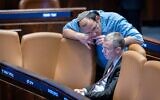 Justice Minister Yariv Levin and Religious Zionism MK Simcha Rothman, architects of the coalition's judicial overhaul, converse during a Knesset plenum session on December 18, 2024. (Chaim Goldberg/Flash90)