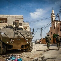 Israeli soldiers operate with their armored vehicles in the West Bank city of Jenin, March 4, 2025. (Nasser Ishtayeh/Flash90)
