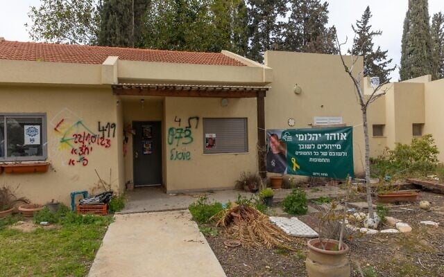 A poster featuring murdered hostage Ohad Yahalomi sits outside a home on kibbutz Nir Oz, March 3, 2025. (Yossi Aloni/FLASH90)