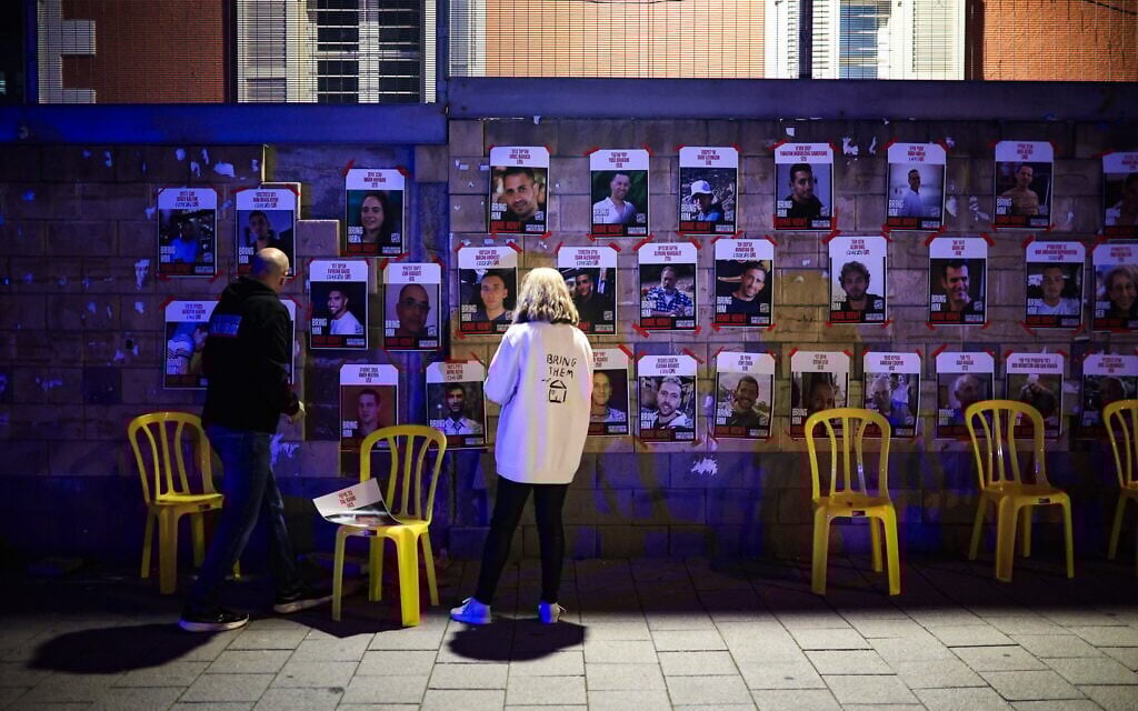 People look at posters of hostages held by Hamas in the Gaza Strip, in Tel Aviv, March 8, 2025. (Itai Ron/Flash90)