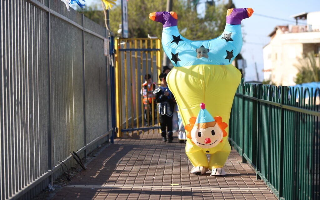 Schoolkids dressed up in costumes ahead of the the Jewish holiday of Purim, in Safed, March 12, 2025. (David Cohen/Flash90)