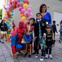 School kids, their teachers and parents dressed up in costumes seen at the Gabrieli Carmel School in Tel Aviv, ahead of the the Jewish holiday of Purim, March 13, 2025. (Avshalom Sassoni/Flash90)