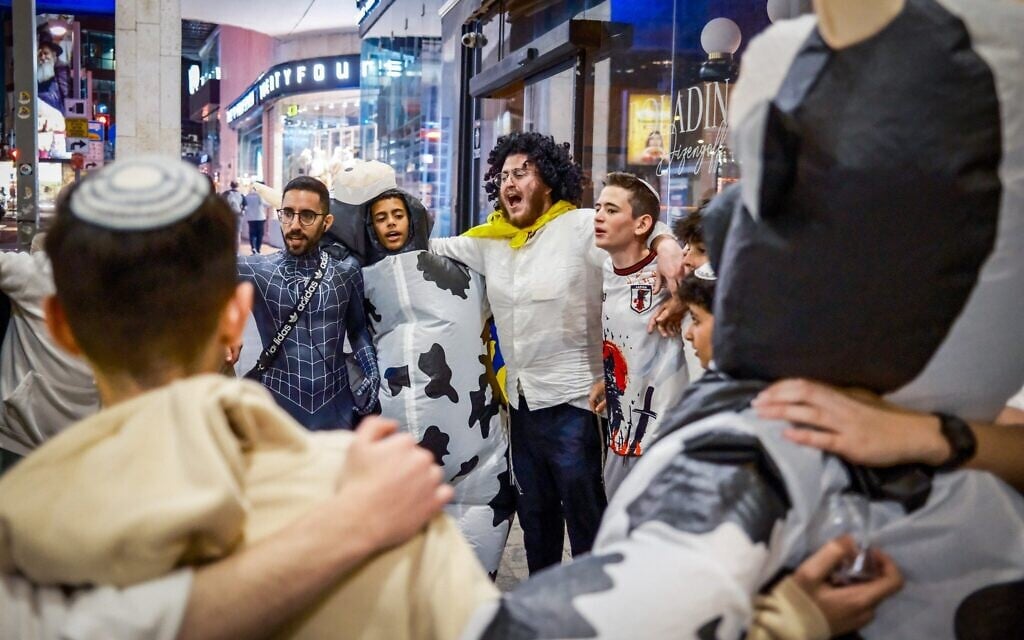 People wearing costumes celebrate the Jewish festival of Purim in Tel Aviv, March 13, 2025. (Dor Pazuelo/Flash90)