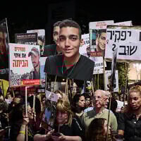 A protester holds up a cutout of Edan Alexander's face at a rally calling for the release of the hostages, at Hostages Square in Tel Aviv, March 15, 2025. (Avshalom Sassoni/Flash90)