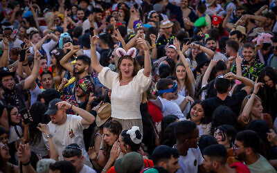 People in costumes party in the Nahlaot neighborhood of Jerusalem, during the Jewish holiday of Purim, on March 16, 2025. (Oren Ben Hakoon/Flash90)