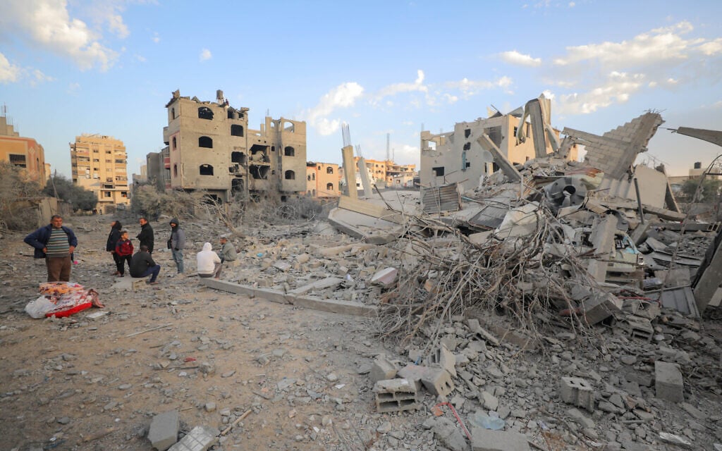 Palestinians at the scene of an Israeli airstrike in Gaza City, on March 18, 2025. (Ali Hassan/Flash90)