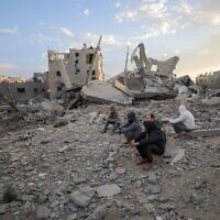 Palestinians at the scene of an Israeli airstrike in Gaza City, on March 18, 2025. (Ali Hassan/Flash90)