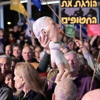 Israelis attend a rally against government moves to fire Shin Bet head Ronen Bar, at Habima Square, March 18, 2025. (Tomer Neuberg/Flash90)