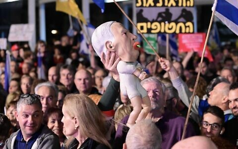 Israelis attend a rally against government moves to fire Shin Bet head Ronen Bar, at Habima Square, March 18, 2025. (Tomer Neuberg/Flash90)