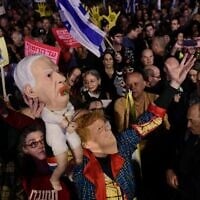 Israelis attend a rally against Prime Minister Benjamin Netanyahu's decision to fire Shin Bet chief Ronen Bar, at Habima Square in Tel Aviv on March 18, 2025. (Tomer Neuberg/Flash90)