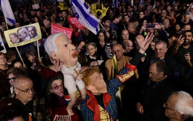Israelis attend a rally against Prime Minister Benjamin Netanyahu's decision to fire Shin Bet chief Ronen Bar, at Habima Square in Tel Aviv on March 18, 2025. (Tomer Neuberg/Flash90) Israelis attend a rally against Prime Minister Benjamin Netanyahu's decision to fire Shin Bet chief Ronen Bar, at Habima Square in Tel Aviv on March 18, 2025. (Tomer Neuberg/Flash90)