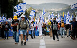 Israelis marching for the release of hostages from Gaza and against efforts by Prime Minister Benjamin Netanyahu to fire Shin Bet head Ronen Bar, on Route 1 outside Jerusalem, March 18, 2025. (Photo by Yonatan Sindel/Flash90)