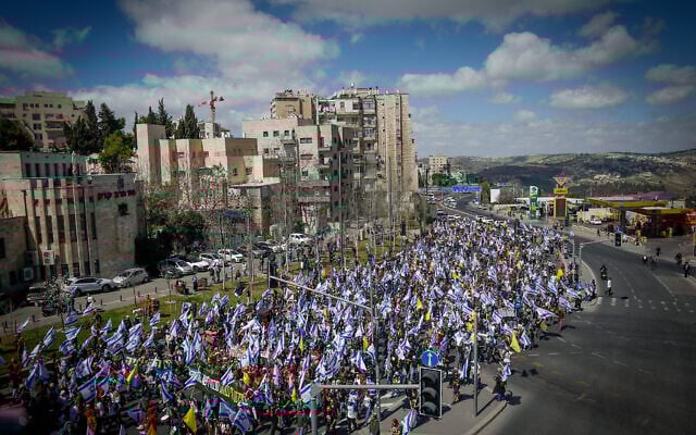 Israelis attend a protest march against the decision of Prime Minister Benjamin Netanyahu to fire Shin Bet head Ronen Bar, on Route 1 near Jerusalem, March 18, 2025. (Yonatan SIndel/Flash90) Israelis attend a protest march against the decision of Prime Minister Benjamin Netanyahu to fire Shin Bet head Ronen Bar, on Route 1 near Jerusalem, March 18, 2025. (Yonatan SIndel/Flash90)