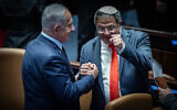 Prime Minister Benjamin Netanyahu congratulates Otzma Yehudit chairman Itamar Ben Gvir after the Knesset votes to approve his return to the cabinet, March 19, 2025. (Yonatan Sindel/Flash90)