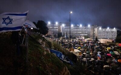 Protesters demonstrate outside the Prime Minister's Office as the cabinet meets on Prime Minister Benjamin Netanyahu's decision to fire Shin Bet head Ronen Bar, in Jerusalem, March 20, 2025. (Chaim Goldberg/Flash90)