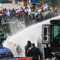 Police fire water cannons at protesters during demonstrations against the decision of Prime Minister Benjamin Netanyahu to fire Shin Bet head Ronen Bar, in Jerusalem, March 20, 2025 (Yonatan Sindel/Flash90)