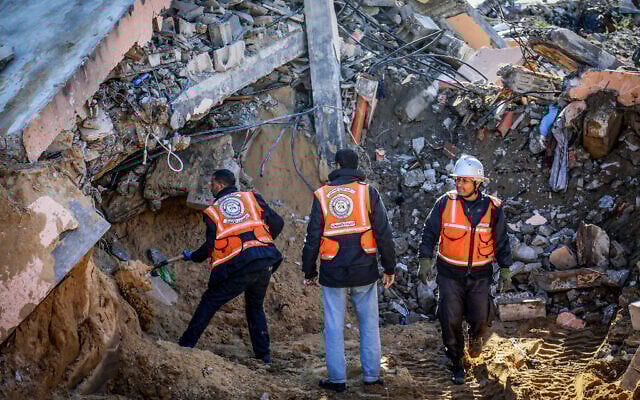 Civil defense personnel work to retrieve bodies from under the rubble of a home in Khan Younis, in the southern Gaza Strip after overnight Israeli airstrikes, March 23, 2025. (Abed Rahim Khatib/Flash90) Civil defense personnel work to retrieve bodies from under the rubble of a home in Khan Younis, in the southern Gaza Strip after overnight Israeli airstrikes, March 23, 2025. (Abed Rahim Khatib/Flash90)