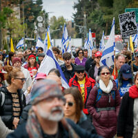 Protesters march from Prime Minister Benjamin Netanyahu's Jerusalem home to his office in a demonstration against his government's attempts to fire the head of the Shin Bet and the attorney general, March 23, 2025. (Yonatan Sindel/Flash90)