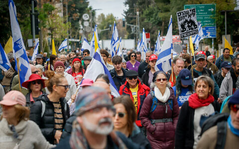 Protesters march from Prime Minister Benjamin Netanyahu's Jerusalem home to his office in a demonstration against his government's attempts to fire the head of the Shin Bet and the attorney general, March 23, 2025. (Yonatan Sindel/Flash90)