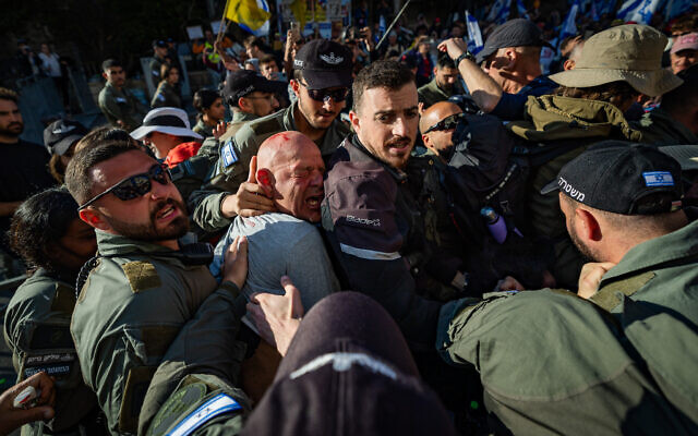 Israelis clash with police during a protest against Israeli prime minister Benjamin Netanyahu and his government, outside the Prime Minister’s Residence in Jerusalem, March 23, 2025. (Yonatan Sindel/Flash90) Israelis clash with police during a protest against Israeli prime minister Benjamin Netanyahu and his government, outside the Prime Minister’s Residence in Jerusalem, March 23, 2025. (Yonatan Sindel/Flash90)