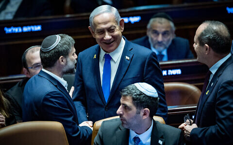 Prime Minister Benjamin Netanyahu (R) and Finance Minister Bezalel Smotrich  in the Knesset plenum ahead of the final vote on the 2025 state budget, March 25, 2025. (Yonatan Sindel/Flash90)