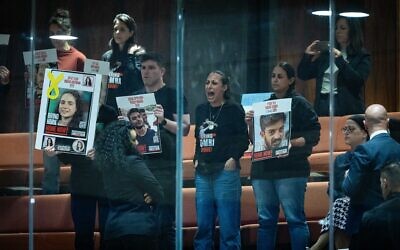 Relatives of Israelis held hostage in the Gaza Strip protest from the visitors' gallery as the 2025 state budget law is passed by the Knesset, March 25, 2025. (Yonatan Sindel/Flash90)