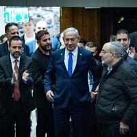 Prime Minister Benjamin Netanyahu (center) with coalition lawmakers as the 2025 state budget law is passed by the Knesset, March 25, 2025. (Yonatan Sindel/Flash90)