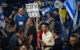 People protest against Prime Minister Benjamin Netanyahu and his government, outside the Knesset, in Jerusalem, March 26, 2025. Poster reads 'Checks and balances.' (Chaim Goldberg/Flash90)