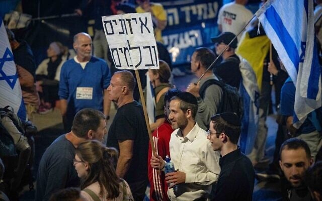 People protest against Prime Minister Benjamin Netanyahu and his government, outside the Knesset, in Jerusalem, March 26, 2025. Poster reads 'Checks and balances.' (Chaim Goldberg/Flash90) People protest against Prime Minister Benjamin Netanyahu and his government, outside the Knesset, in Jerusalem, March 26, 2025. Poster reads 'Checks and balances.' (Chaim Goldberg/Flash90)