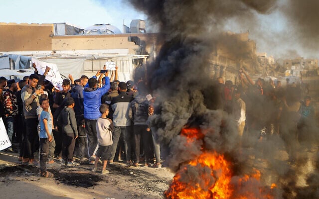 Palestinians take part in an anti-Hamas protest, calling for an end to the war with Israel, in Beit Lahiya in the northern Gaza Strip, March 26, 2025. (Flash90) Palestinians take part in an anti-Hamas protest, calling for an end to the war with Israel, in Beit Lahiya in the northern Gaza Strip, March 26, 2025. (Flash90)