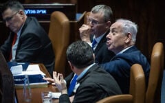 Prime Minister Benjamin Netanyahu (right), Justice Minister Yariv Levin (to his right) and other ministers in the Knesset plenum during a vote on a law to remake Israel's judicial appointments process, March 27, 2025. (Chaim Goldberg/Flash90)