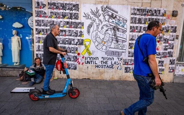 Israelis walk past a mural photographs of Israelis held hostage by Hamas terrorists in Gaza since the October 7, 2023, massacre, in Tel Aviv, March 27, 2025. (Nati Shohat/Flash90) Israelis walk past a mural photographs of Israelis held hostage by Hamas terrorists in Gaza since the October 7, 2023, massacre, in Tel Aviv, March 27, 2025. (Nati Shohat/Flash90)