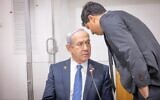 Prime Minister Benjamin Netanyahu speaks with his lawyer Amit Hadad (R) at a hearing in his corruption trial at the Tel Aviv District Court, March 31, 2025 (Miriam Alster/Flash90)