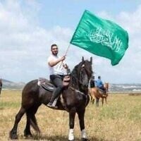 Undated photo of Kafr Kanna resident Jihad Zureiqat waving a Hamas flag (Israel Police)