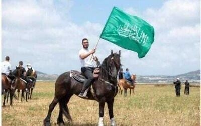 Undated photo of Kafr Kanna resident Jihad Zureiqat waving a Hamas flag (Israel Police)