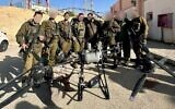 IDF troops stand with a drone that was used in an attempted drug smuggling on the Egyptian border, March 25, 2025. (Israel Defense Forces)