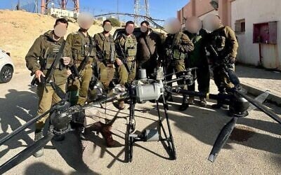 IDF troops stand with a drone that was used in an attempted drug smuggling on the Egyptian border, March 25, 2025. (Israel Defense Forces)
