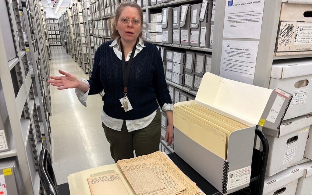 YIVO director of archives Stefanie Halpern stands before a box of questionnaires used to gather information on Yiddish culture in the early 1920s, at the YIVO archives in New York City, March 2025. (Cathryn J. Prince)