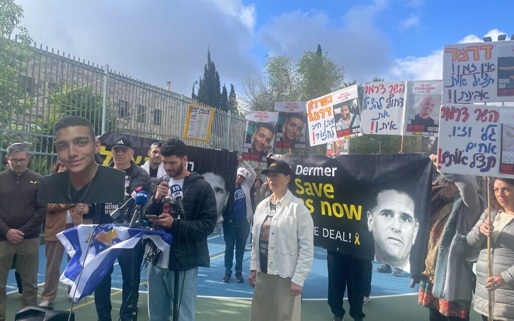Ilay David, center, brother of  hostage Evyatar David, with members of Edan Alexander’s family in Jerusalem on March 30, 2025 (Jessica Steinberg/ Times of Israel)