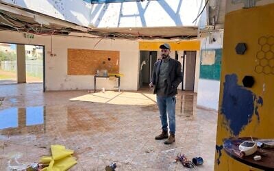Adeb Mazal, head of the Bedouin village Arab al-Aramshe, stands in the community center that was destroyed in an April 2024 Hezbollah rocket attack on March 2, 2025. (Diana Bletter/Times of Israel)