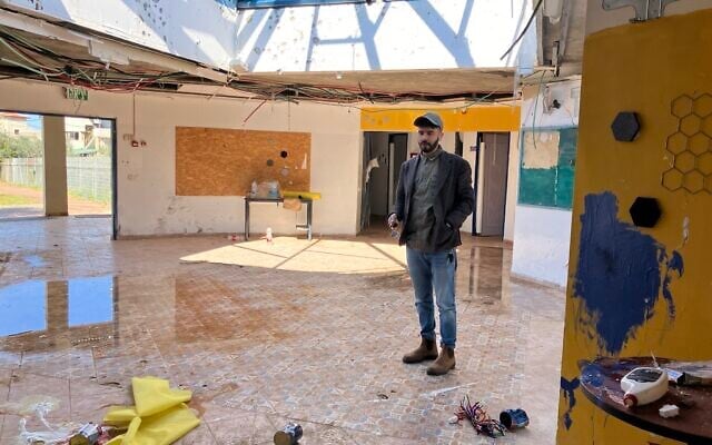 Adeb Mazal, head of the Bedouin village Arab al-Aramshe, stands in the community center that was destroyed in an April 2024 Hezbollah rocket attack on March 2, 2025. (Diana Bletter/Times of Israel)