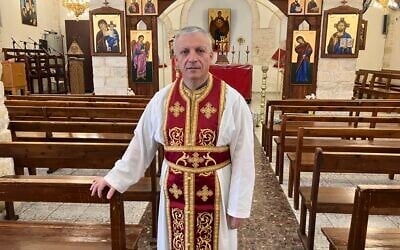 Father Michael Assi after Sunday morning services at Mar Elias Church in Fassuta on March 23, 2025. (Diana Bletter/Times of Israel)