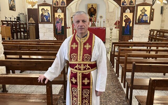 Father Michael Assi after Sunday morning services at Mar Elias Church in Fassuta on March 23, 2025. (Diana Bletter/Times of Israel)