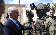 Prime Minister Benjamin Netanyahu, left, visit the undercover Border Police "Mista'arvim" unit, March 19, 2025. (Amos Ben Gershom/GPO)