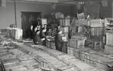 Leaders of the New York-based YIVO open crates of salvaged YIVO treasures from Europe, photographed in New Jersey, 1947. (Courtesy of the YIVO Institute for Jewish Research)